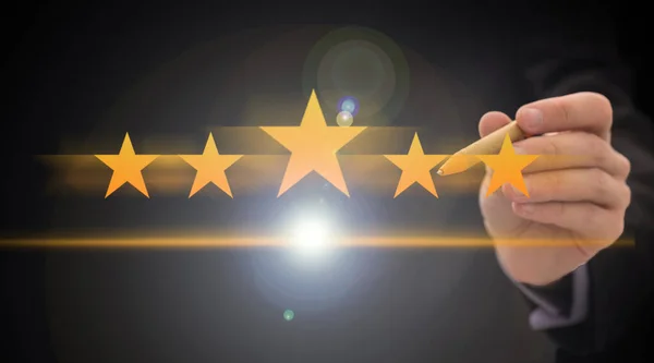 Review, increase rating or ranking, evaluation and classification concept. Businessman draw five yellow star to increase rating of his company. Bokeh in background. . High quality photo