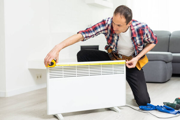 Handyman fix the radiator in the room. High quality photo