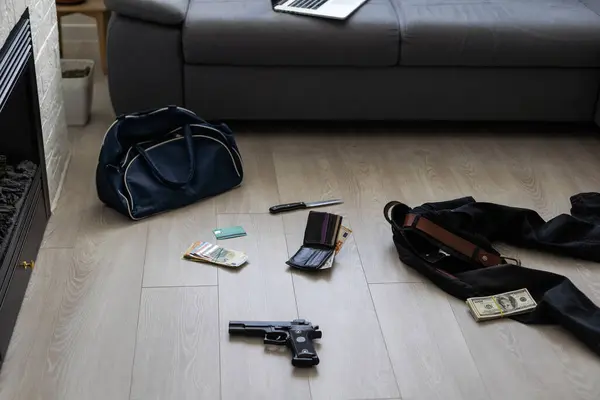 Crime scene investigation - numbering of evidences after the murdering in apartment. Brass knuckle, wallet and clothes with evidence markers. High quality photo