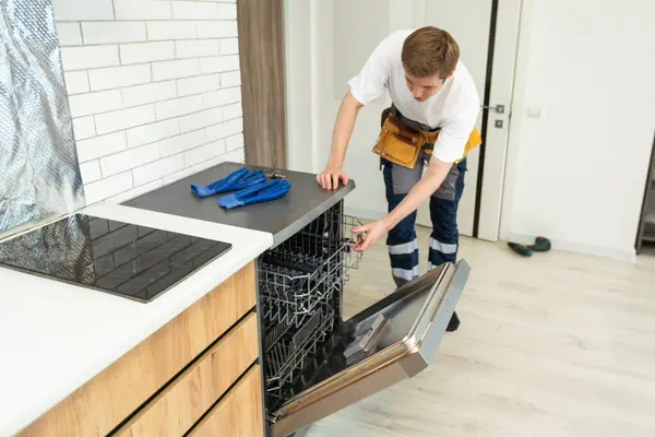 Technician Worker Uniform Installs Dishwasher Kitchen Furniture Repairman Wear Worker — Stock Photo, Image