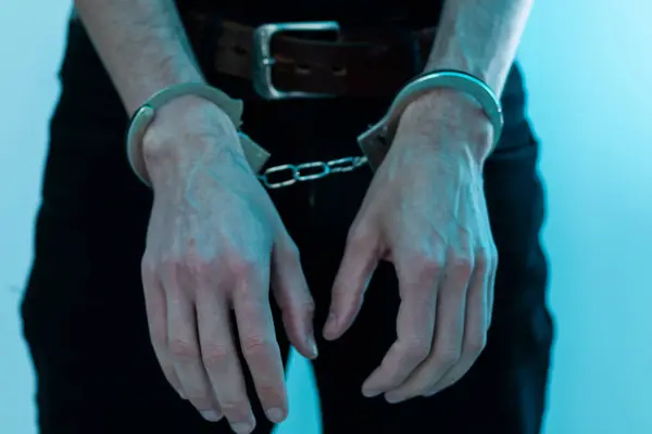 prisoner concept, Handcuffed hands of a prisoner in prison, Male prisoners were severely strained in the dark prison, violence. High quality photo