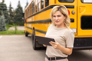 a woman near a school bus.
