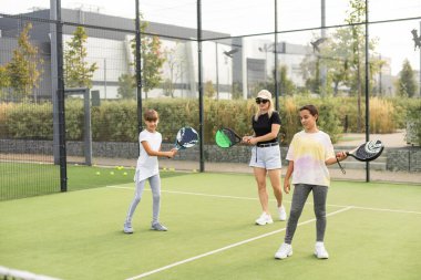 Anne ve kızları dışarıda Padel oynuyorlar. Yüksek kalite fotoğraf