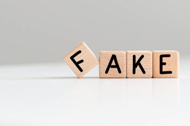 Beyaz arka planda tahta bloklarla yazılmış sahte bir kelime. Yüksek kalite fotoğraf