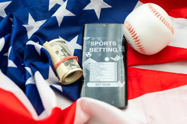 American traditional sports game. Baseball. Concept. Baseball ball and bats on table with american flag. High quality photo