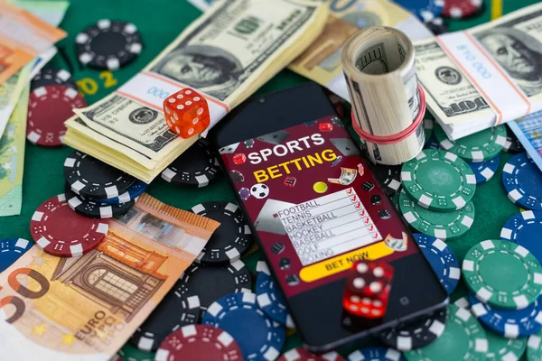 pile of casino chips and toy car, smartphone with betting on sports. High quality photo