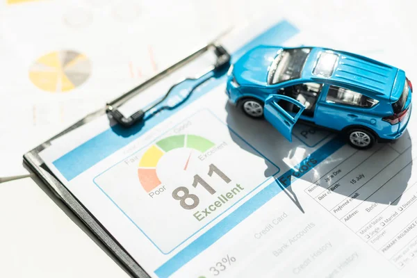 Toy car, money, documents and calculator on table. Car insurance concept. High quality photo