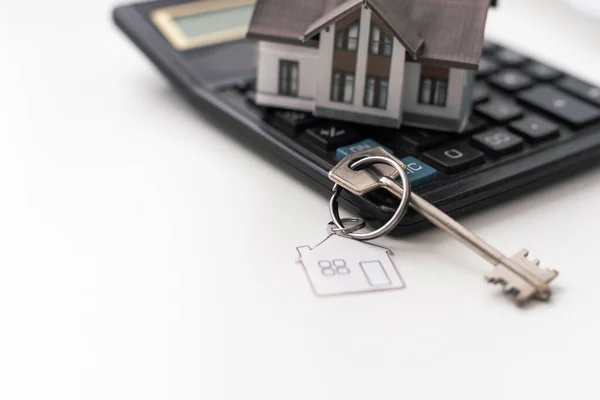 Mortgage application concept with house keys and calculator. High quality photo