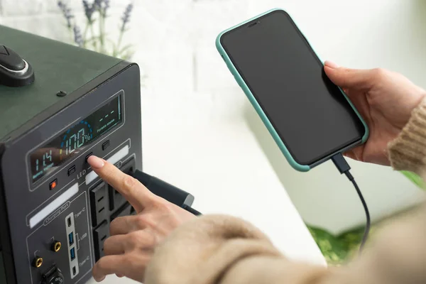 Charging mobile phone battery with wireless charging device in the table. Smartphone charging on a charging pad. Mobile phone near wireless charger Modern lifestyle technology