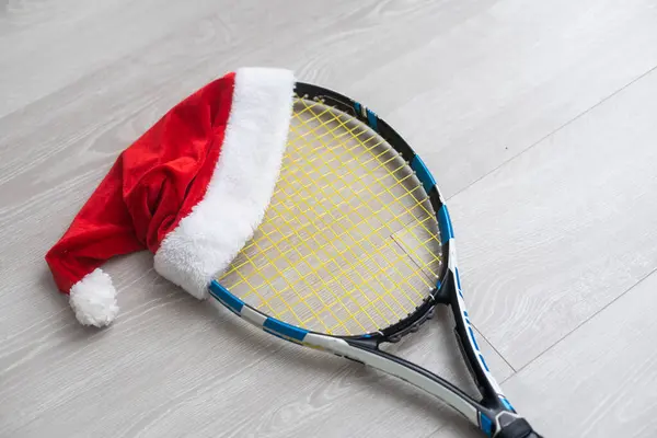 santa hat on tennis racket on white background.