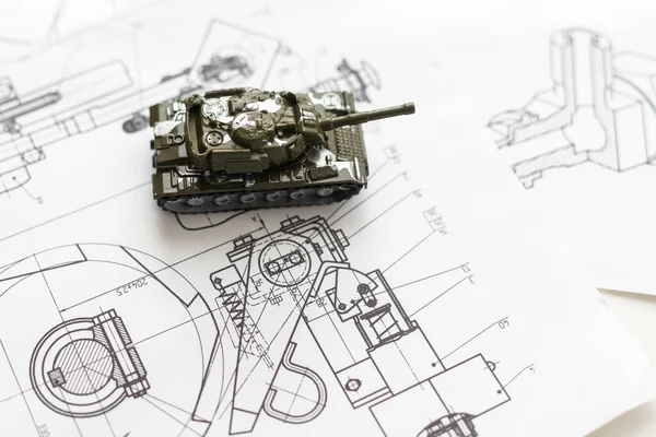 The toy tank is on the table. Childrens toy military tank. High quality photo