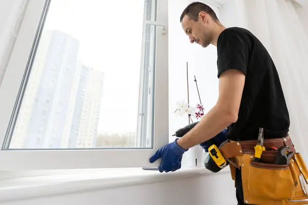 Worker in installing rubber seals on plastic upvc window. High quality photo