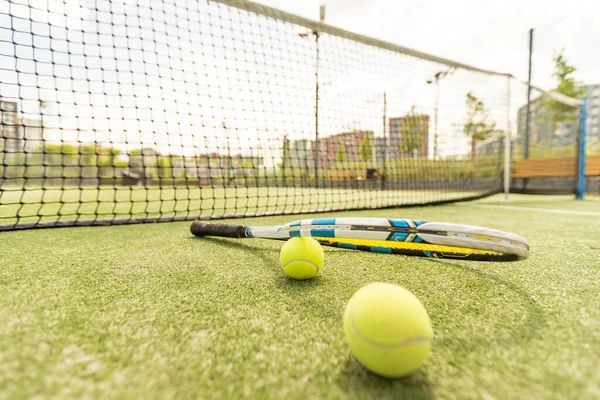 tennis racket with a tennis ball on a tennis court.