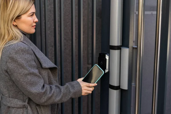 Woman hands using phone scan to digital door lock security systems at home