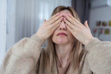 kadının gözleri elleriyle kapsar..