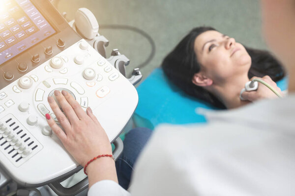 Woman endocrinologist making ultrasonography to a female patient in an ultrasound office. Ultrasound diagnostics.