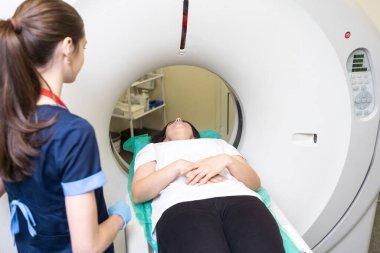 Modern bir hastanede bilgisayarlı tomografi tomografisi çektiren güzel, genç bir kadın..