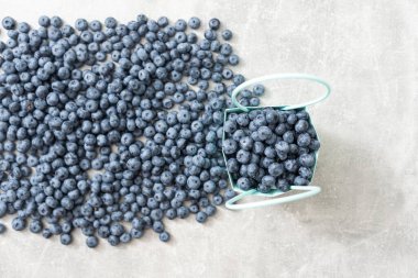 large blueberries in a green market basket.