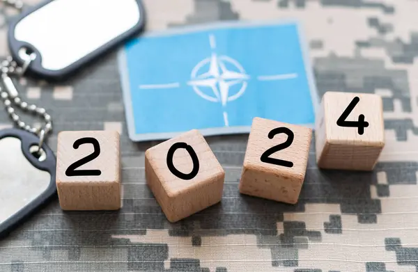 Goals moving forward to 2024, road to next, numbers on wooden box on blue background.,Entering 2024. High quality photo