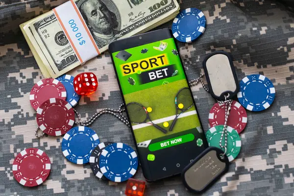 pile of casino chips and toy car, smartphone with betting on sports. High quality photo