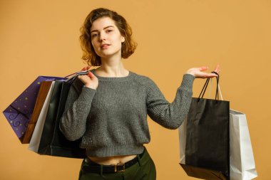 Portrait of happy beautiful shopaholic woman carry shopping bags, advertising concept isolated banner background.