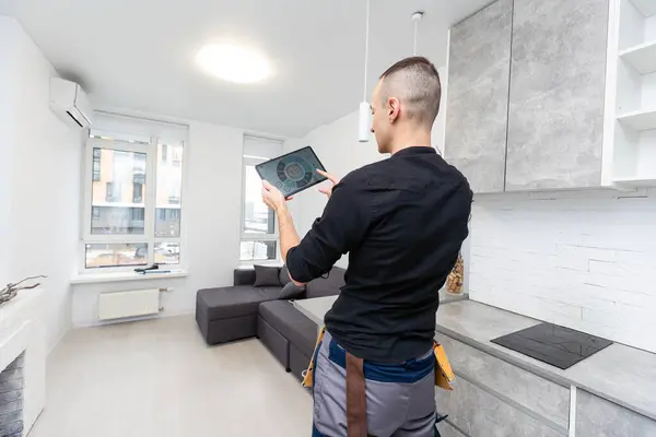 automation, internet of things and technology concept - man looking at tablet pc computer at smart home. High quality photo