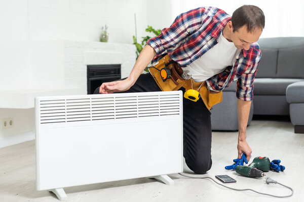 Handyman fix the radiator in the room. High quality photo