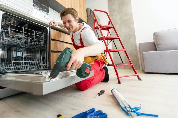 Master of Maintenance: Young Man Providing Home Appliance Repair Services.