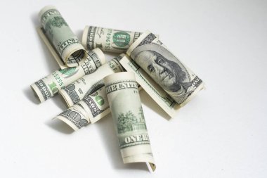 Roll of 100 dollar bills on background.