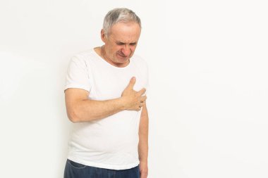 an elderly man has a heartache.