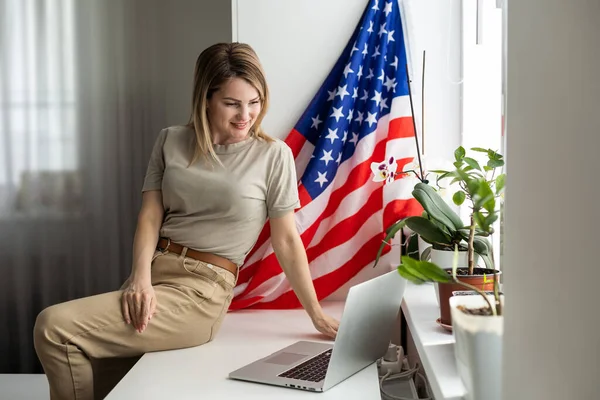 woman with laptop and usa flag. Foreign languages learning, educational online course. High quality photo