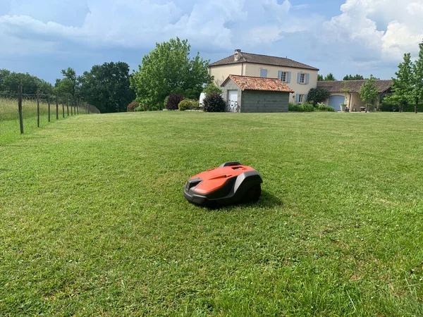 stock image Robotic lawn mower on grass, side view. High quality photo