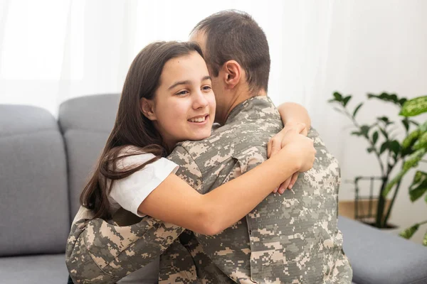 pretty little girl hugging her military father. High quality photo