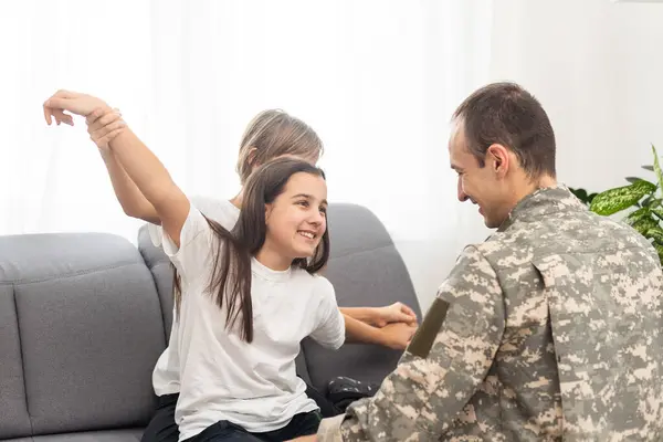 military father and two daughters at home. High quality photo