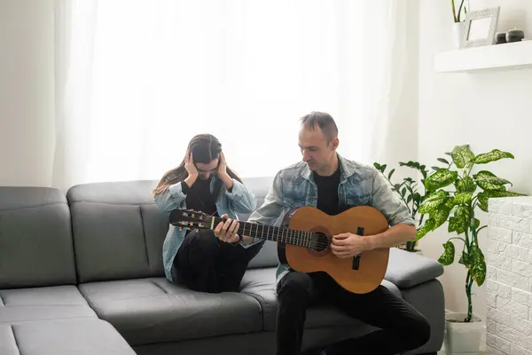 Happy family Father and daughter playing guitar. Fathers day. High quality photo