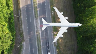 plane flies above the landscape. Side view of aircraft. Travel and transportation concept clipart