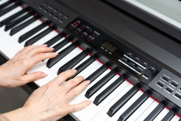 keyboard and hands playing the piano. High quality photo