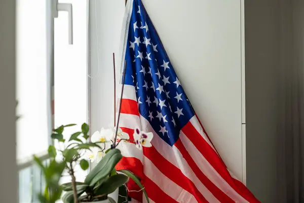 Interior of stylish room with modern workplace and USA flag. High quality photo