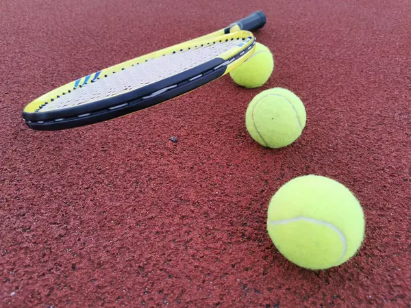 tennis racket with a tennis ball on a tennis court. High quality photo