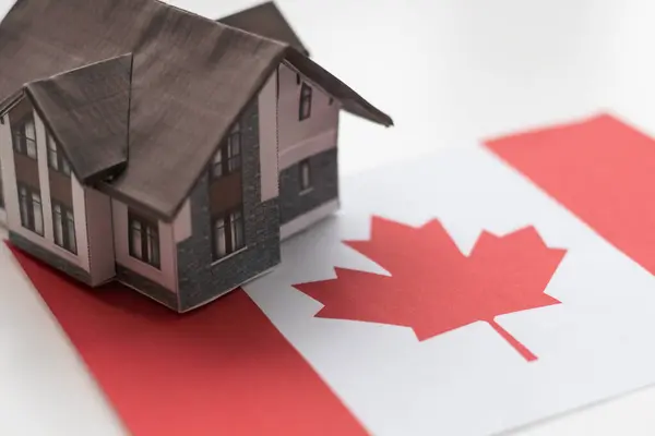 wooden house with flag of Canada Finance, investment, mortgage, loan and credit concept. High quality photo