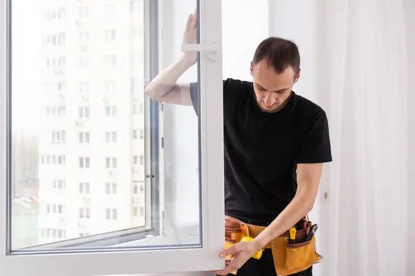 Construction worker installing new window in house. High quality photo