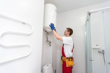 Professional engineer doing a boiler inspection at home.