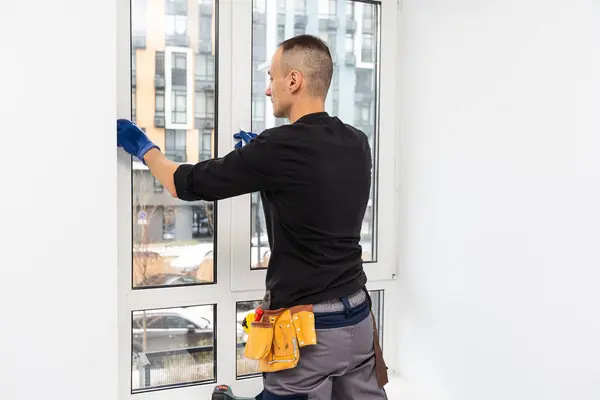 Construction worker repairing window in house. High quality photo