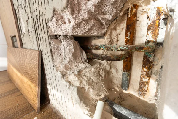 Water damaged wall in an old house. Water damage building interior. wall house broken. Ceiling concrete crack and exposed the rusty steel bar frame. High quality photo