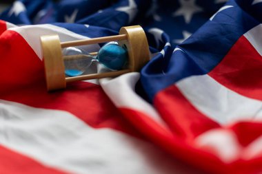 Hourglass and USA flag, soft focus, copy space. High quality photo clipart