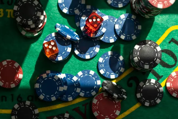 Gambling theme. Colorful playing chips in stacks on green table close up. High quality photo