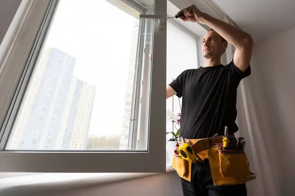 Construction worker installing new window in house. High quality photo