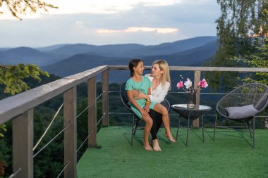 Woman mama in light clothes have fun with cute child girl. Mother and little kid daughter. Mothers Day, love family, parenthood childhood concept.