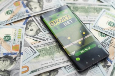 Akıllı telefon ve yakın plan para ile kumar mobil uygulaması. Spor ve bahis konsepti. Yüksek kalite fotoğraf