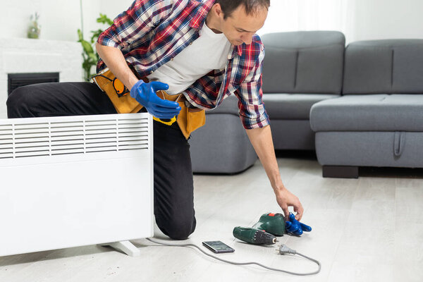 plumber at work. Installing water heating radiator. High quality photo